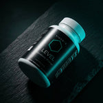 VIGORYS LEVEL Metabolic Primer bottle angled on dark slate surface showing front label and supplement facts panel, SHIFT Protocol metabolic optimization supplement with teal accent lighting