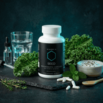 VIGORYS SEED Synbiotic Capsules 60-count bottle - 40 billion CFU probiotic with MAKTREK bypass technology for gut colonization, featuring minimalist black packaging with teal accent and NEXUS protocol designation. The bottle is surrounded by a variety of props for a lifestyle product photography shot. 